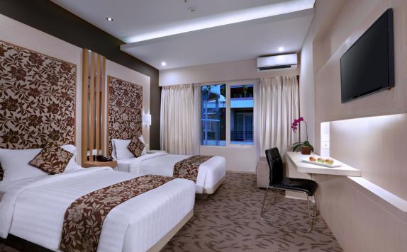 kamar tidur di Quest San Hotel Denpasar