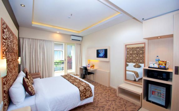 kamar tidur di Quest San Hotel Denpasar